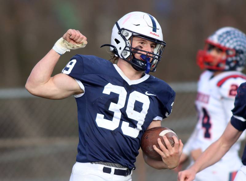 Cary-Grove’s Holden Boone flexes his muscles after a touchdown run against Belvidere North in IHSA Class 6A quarterfinal playoff football action on Saturday, Nov. 16, 2024, at Al Bohrer Field on the campus of Cary-Grove High School in Cary.