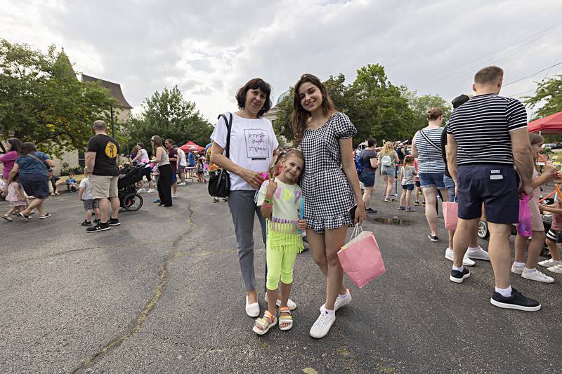 Ukrainian refugees Tetiana (left), Veronika and Elina Chernova, 5, spend the day experiencing Petunia Fest Friday, June 30, 2023 in Dixon.