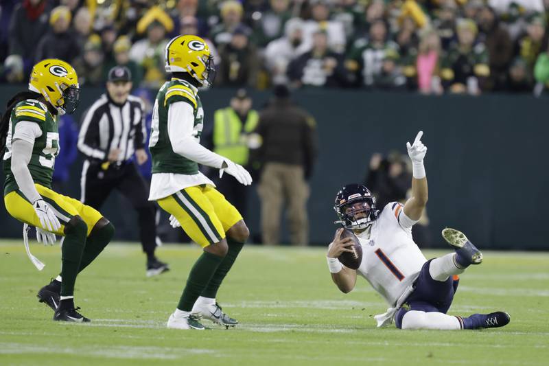 Chicago Bears quarterback Justin Fields runs for a first down during the first half Sunday, Dec. 12, 2021 against Green Bay Packers in Green Bay, Wis.
