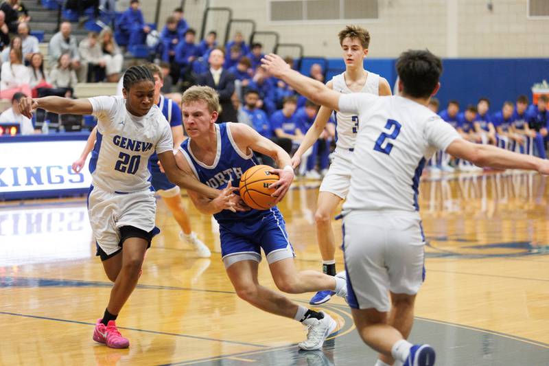 Wheaton North's Henry Schlickman drives the lane against Geneva's David Udoiwod on Friday, Feb.13,2026 in Geneva.