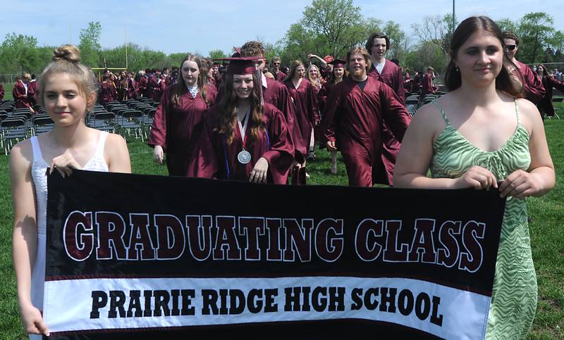 Graduates are led off the football field Saturday, May 14, 2022, during the graduation ceremony at Prairie Ridge High School.