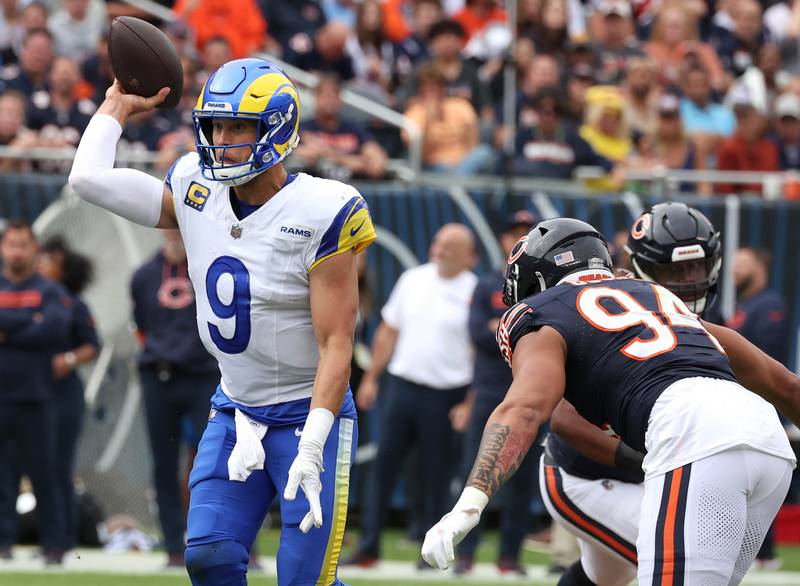 Los Angeles Rams quarterback Matthew Stafford gets rid of the ball just before taking a hit from Chicago Bears defensive end Austin Booker during their game Sunday, Sept. 29, 2024, at Soldier Field in Chicago.