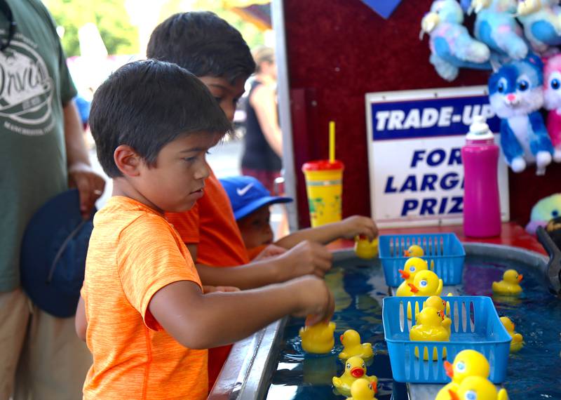 Noah Rosa plays a carnival game at the 2024 Sugar Grove Corn Boil on Friday, July 26, 2024.