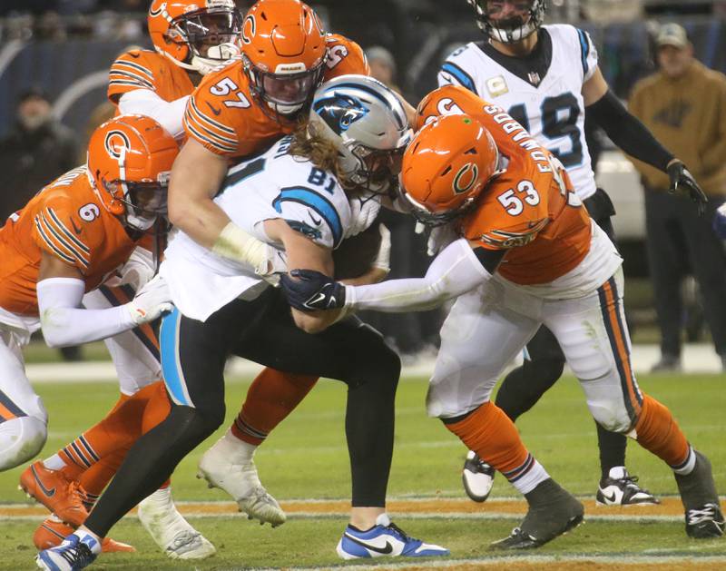 Carolina Panthers tight end Hayden Hurst runs the ball as Chicago Bears players Kyler Gordon, Jack Sanborn and TJ. Edwards brings him down on Thursday, Nov. 9, 2023 at Soldier Field.