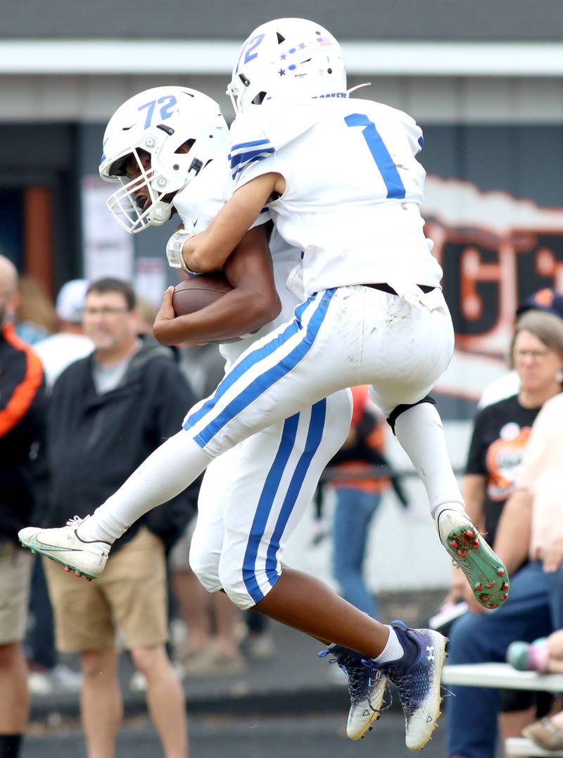 Burlington Central’s AJ Jenkins, left, and Ryder Bergemann celebrate a Jenkins touchdown run in varsity football at Crystal Lake Saturday.