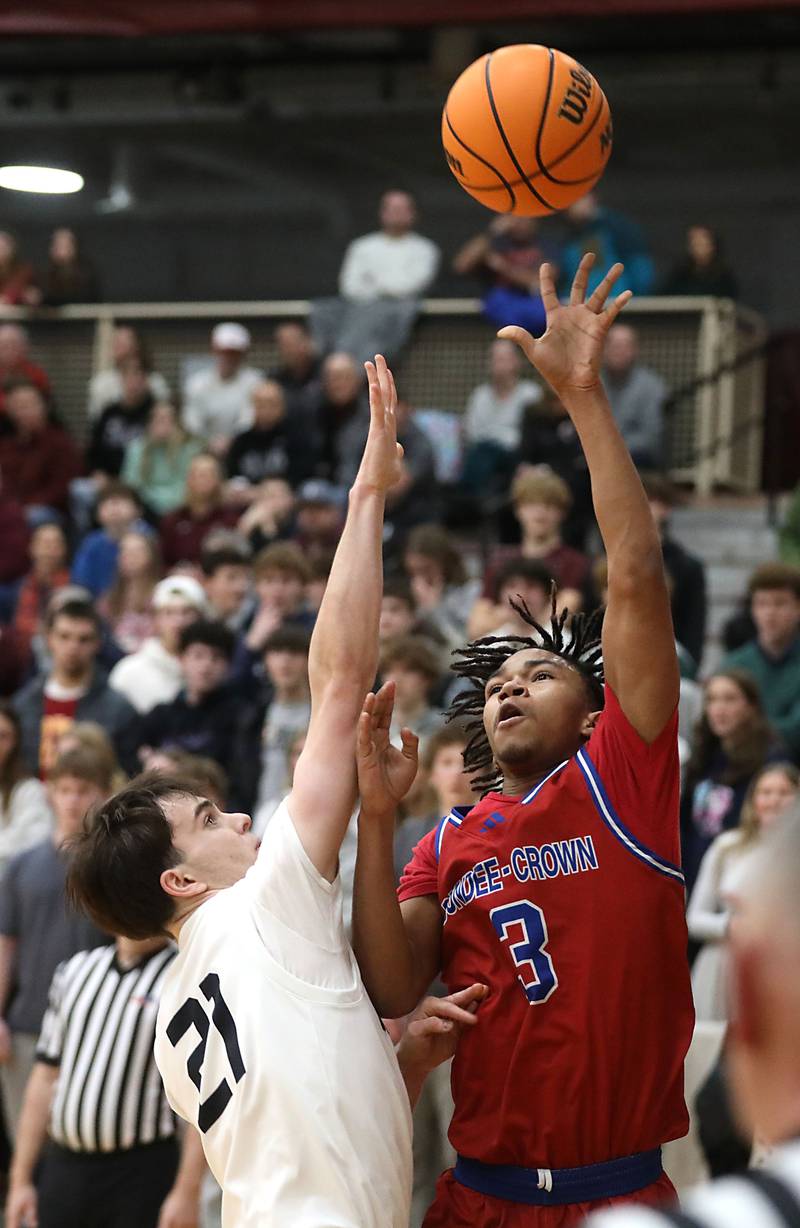Dundee-Crown's Rasheed Trice (right) drives to the basket against Prairie Ridge's Brendan Beu during a Fox Valley Conference boys basketball game on Friday, Jan. 16, 2026, at Prairie Ridge High School in Crystal Lake.