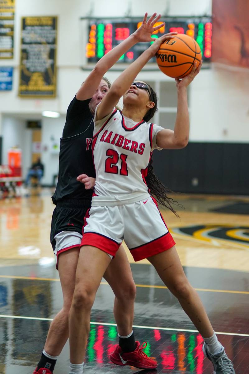 Bolingbrook's Skylar Wakefield (21) shoots the ball in the paint against Yorkville's Elaine Gussman (12) during a Class 4A Metea Valley Regional final basketball game at Metea Valley High School in Aurora on Friday, Feb. 21, 2025.