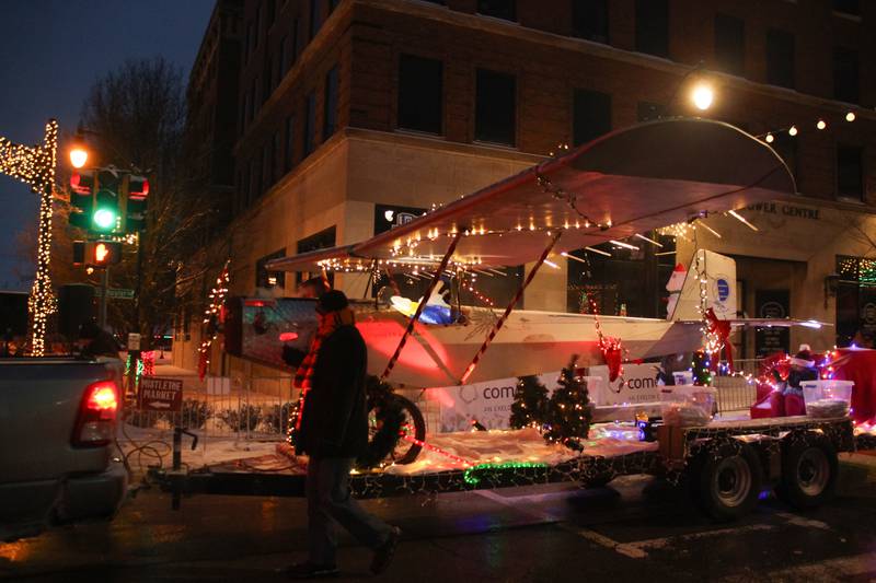 An airplane is featured on the EAA Chapter 990 float as it travels along South Schuyler Avenue for the Kankakee Christmas Parade on Saturday, Dec. 13, 2025.
