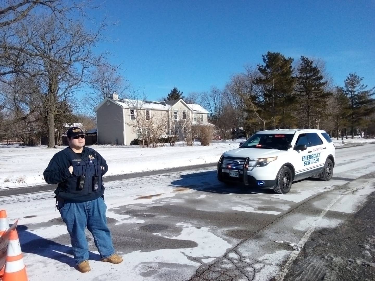 Joel Werner, deputy chief with Manhattan Emergency Management, stands at a roadblock at Manhattan-Monee and Cedar roads as an investigation into the school bus accident continued after 11 a.m. on Thursday, Jan. 11, 2026.