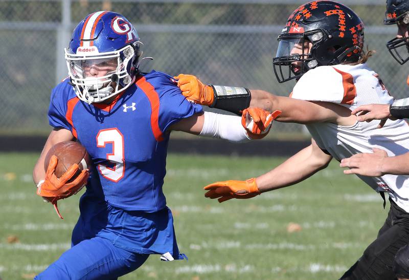 Genoa-Kingston's Brody Engel escapes the grasp of an Elmwood defender during their first round playoff game Saturday, Oct. 29, 2022, at Genoa-Kingston High School.
