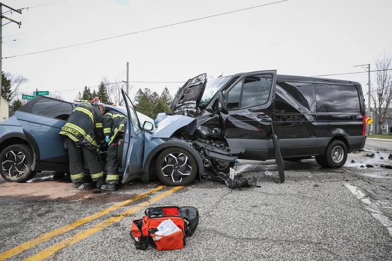 Firefighters rush to the scene of a two-vehicle crash with a driver who was entrapped in their vehicle for almost 40 minutes in Cary on Tuesday, April 19, 2022.