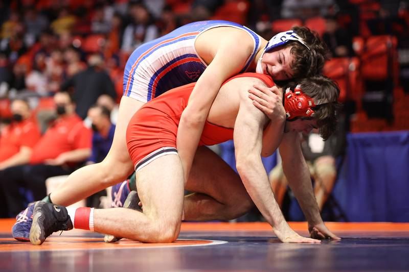 Marmion’s Tyler Perry Marist’s works over Jake Liberatore in the Class 3A 170lb. semifinals at State Farm Center in Champaign. Friday, Feb. 18, 2022, in Champaign.