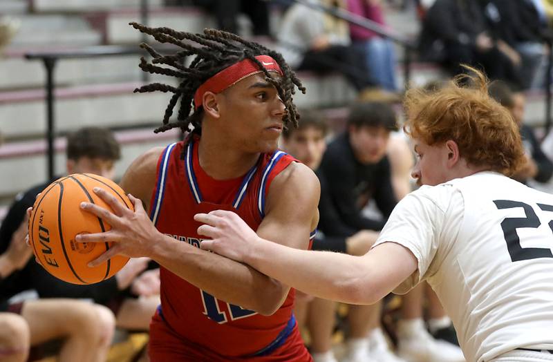 Dundee-Crown's Anthony Spain looks to pass as he is guarded by Prairie Ridge's Johnny Kemp during a Fox Valley Conference boys basketball game on Friday, Jan. 16, 2026, at Prairie Ridge High School in Crystal Lake.