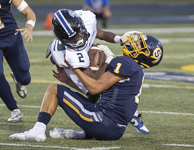 St. Francis’ Ian Willis is pulled down by Sterling’s Joseph Holcomb Friday, Sept. 1, 2023 at Sterling High School.