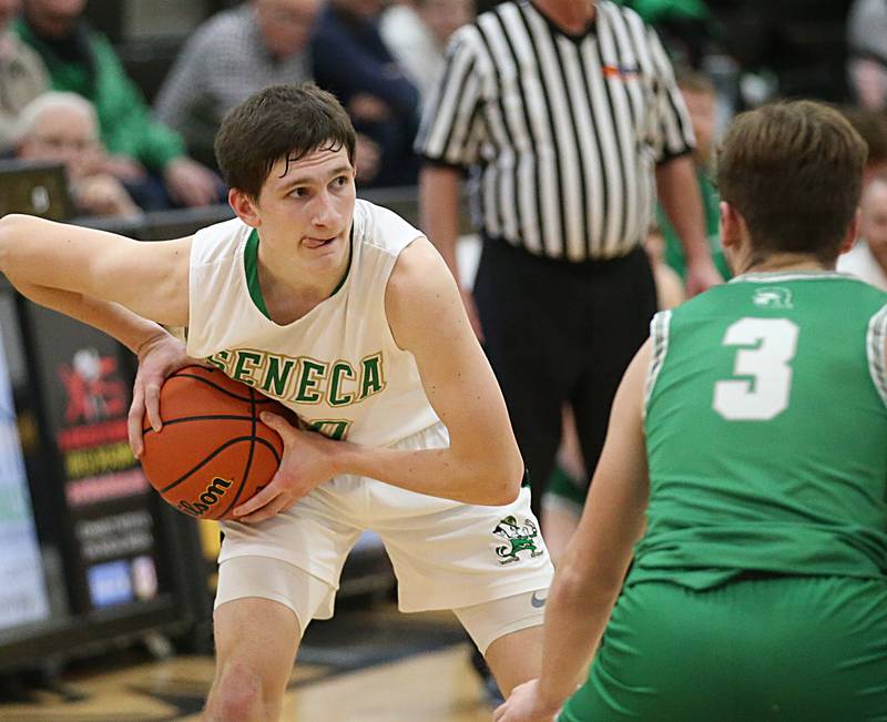 Seneca's Calvin Maierhofer looks to pass the ball around Dwight's Connor Telford during the Tri-County Conference Tournament on Wednesday, Jan. 25, 2023 at Putnam County High School.