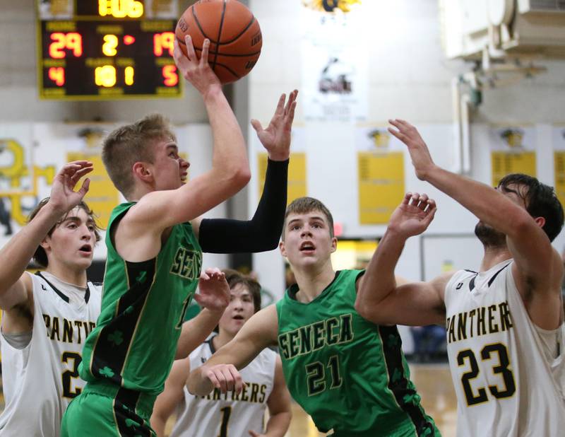 Seneca's Paxton Giertz (left) drives to the hoop as Putnam County's Jackson McDonald (right) defends on Friday, Dec. 16, 2022 at Putnam County High School.