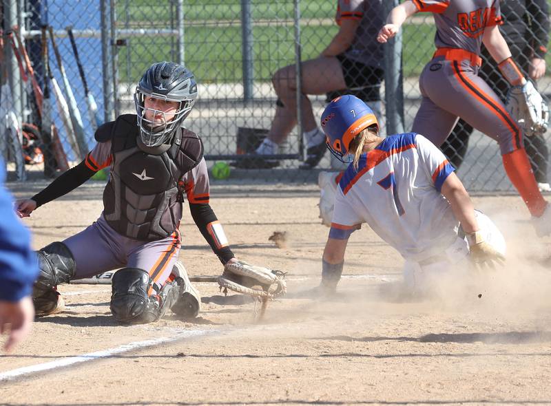 Genoa-Kingston's Elizabeth Davis slides past DeKalb's Madison Hallaron scoring a run Thursday, May 8, 2025, during their game at Genoa-Kingston High School.