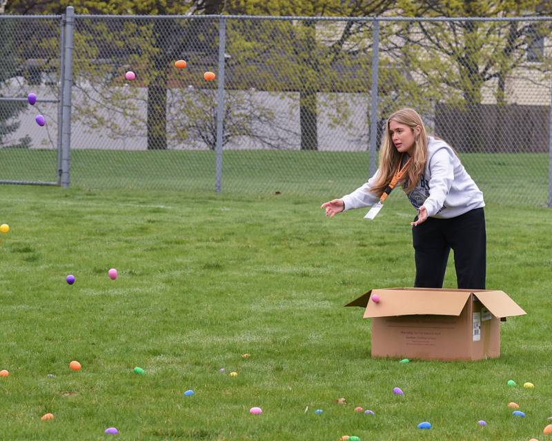York High School junior Avery Patterson helps place Easter eggs on the baseball field on Saturday April 19, 2025, held at Berens Park in Elmhurst.
