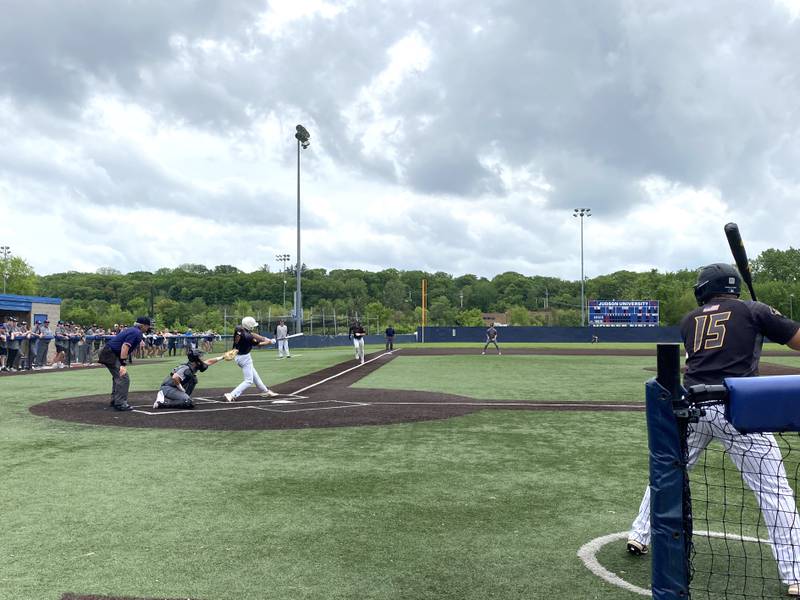 Harvest Christian catcher Ben Mitchell squeezes the pitch following Putnam County batter Jackson McDonald's swing while baserunner Andrew Pyszka races home from third on a miscommunicated squeeze play Thursday, May 26, 2022, during the Class 1A Harvest Christian Sectional semifinals in Elgin.