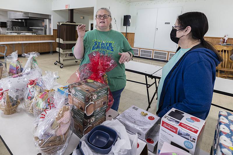Organizer Emily Garrick (left) talks about the joy the clients feel when shopping for their loved ones. “They love to give and they live on a limited budget. They’re really excited for the shop," she said. Clients can shop on the Self Help cafeteria on Saturday, Dec. 3.