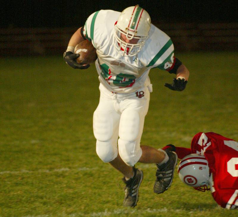 La Salle-Peru's Eric Veselsky (40) tries to avoid being tripped up by an Ottawa defender during the 2002 game at King Field.