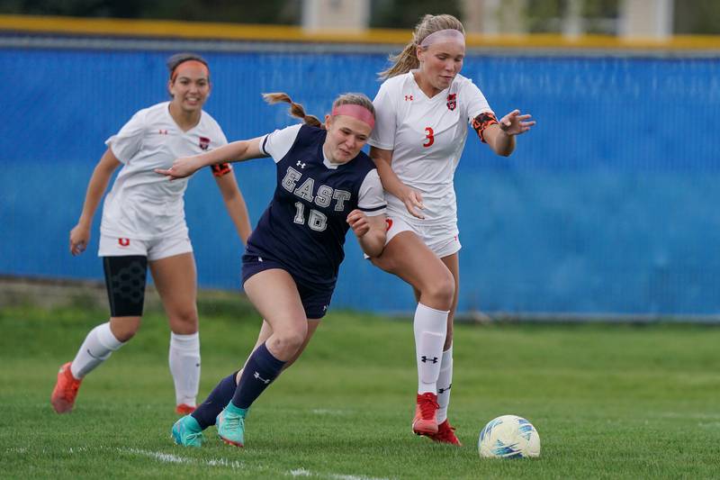 Oswego East's Catie Sloan (16) challenges Oswego’s Gillian Young (3) for the ball during a soccer match at Oswego East High School on Tuesday, April 23, 2024.