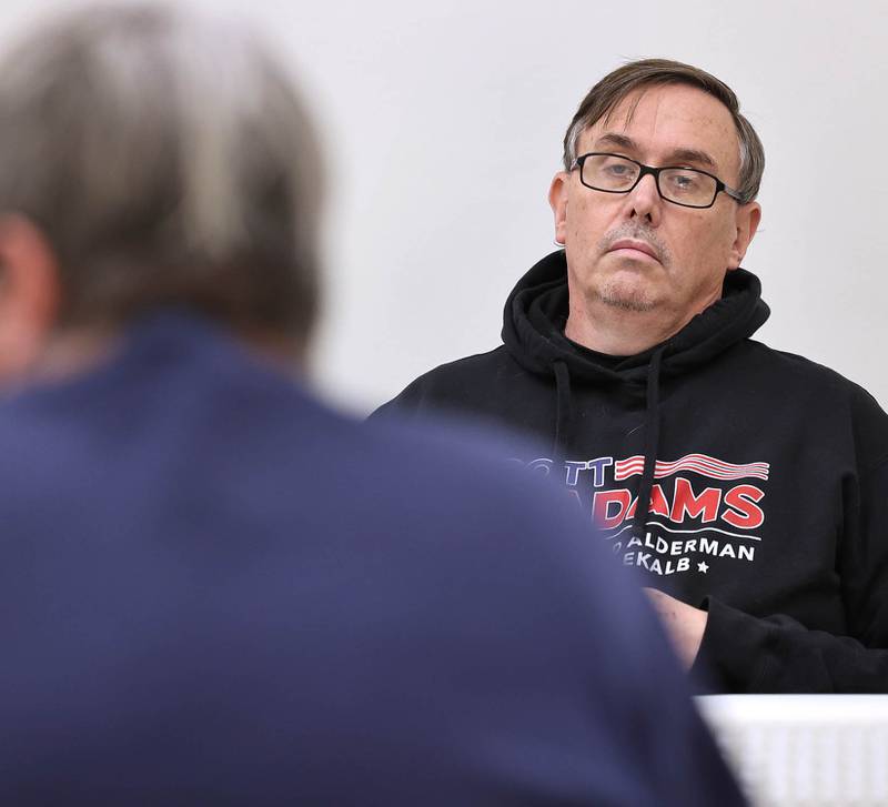 DeKalb City Council Ward 5 alderman Scott McAdams (right) listens as Derek Van Buer, one of the two DeKalb residents who filed objections against him, speaks Friday, Jan. 13, 2023, during a City of DeKalb Electoral Board hearing. The hearing was held to decide if incumbent McAdams, who is running unopposed for DeKalb’s 5th Ward aldermanic seat, should be removed from the ballot due to objections filed by two residents regarding signatures and filing procedure.