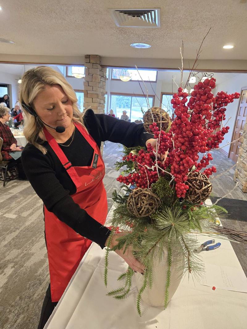 Gina Cordes, of Boxed and Bloom Decor, demonstrating making arrangements for the holidays.