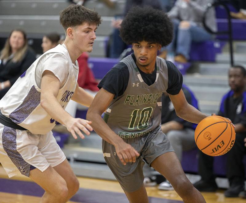 Plainfield Central’s Alexis Landfair drives against Dixon’s Jackson Koehler Friday, Jan. 3, 2025, at Dixon High School.
