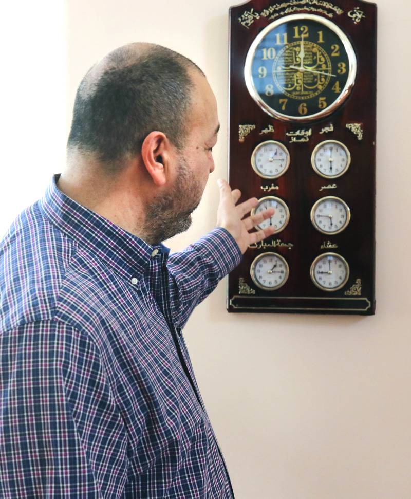 Mohammed Labadi, president of the Islamic Center of DeKalb, talks Friday, April 7, 2023, at the mosque, about a clock that shows the five times for prayer that Muslims are obligated to adhere to that hangs on a wall in the prayer hall, or musallā.