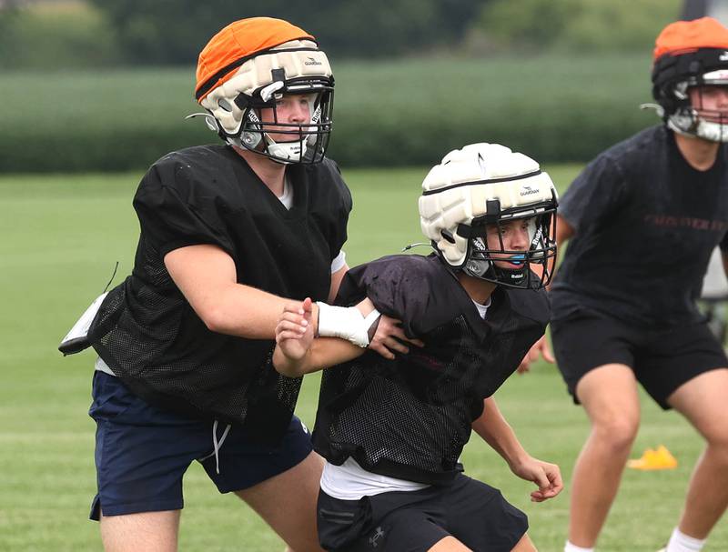 Kaneland’s Rogan O’Neil (left) picks up a receiver in pass coverage Monday, Aug. 18, 2025, during practice at the school in Maple Park.