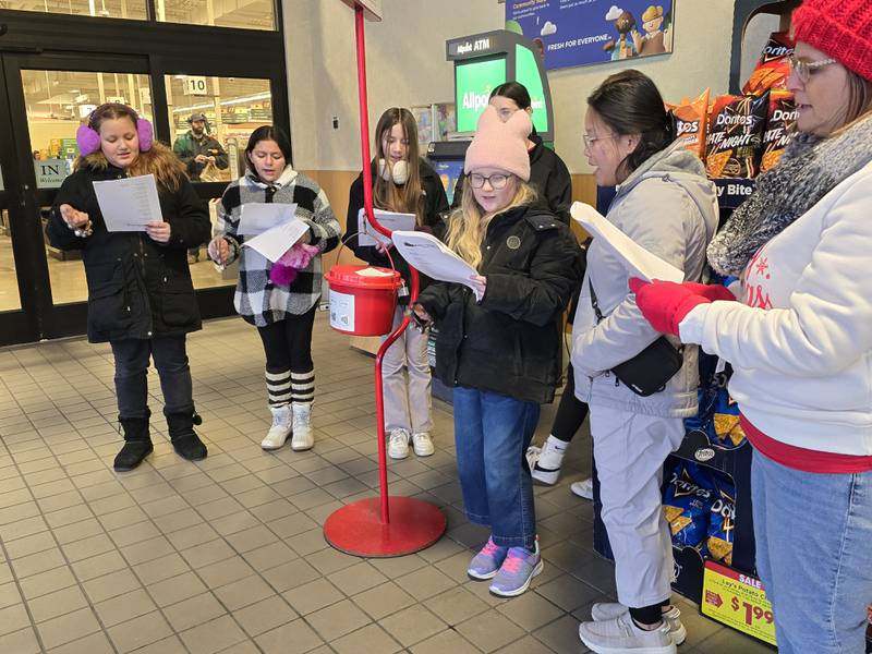 Northlawn Junior High School Student Council and choir members ring bells Wednesday, Dec. 11, 2024, for the Salvation Army at Kroger in Streator.