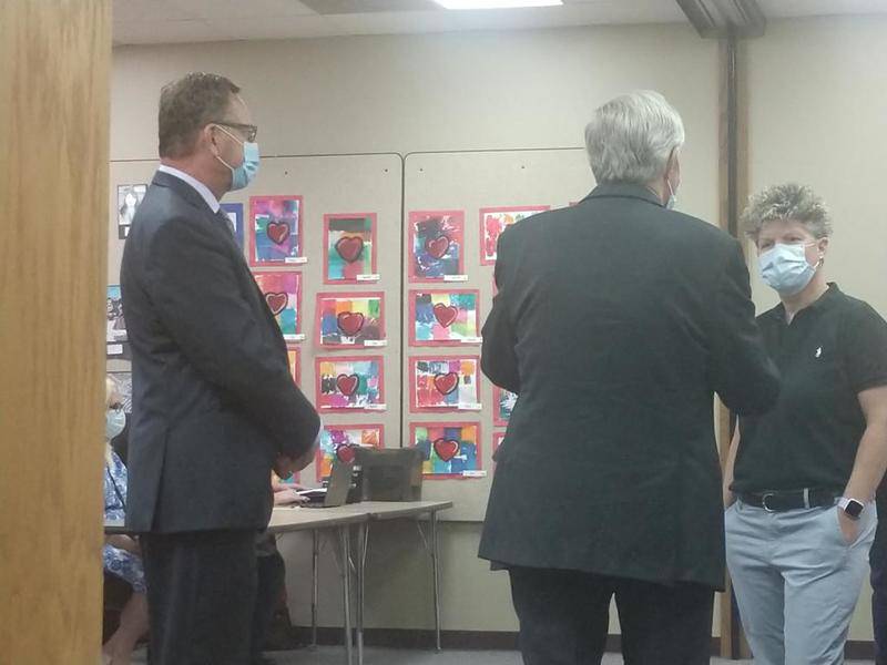 DeKalb interim superintendents Ray Lechner (left) and Griff Powell (center) talk to board member Victoria Newport last week.