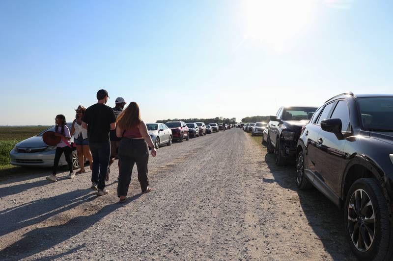Attendees walk along the gravel road leading to the 50th Pembroke Rodeo on Sunday, May 24, 2026.