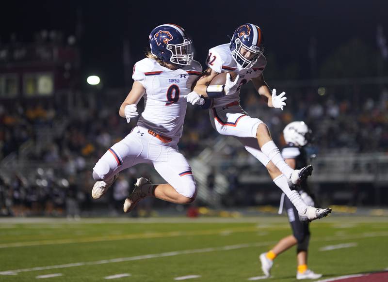 Oswego’s Ben Pavlick (9) celebrates with Michael Kelly (22) after a Kelly touchdown against Plainfield North during a football game at Plainfield North High School on Friday, Sept. 22, 2023.