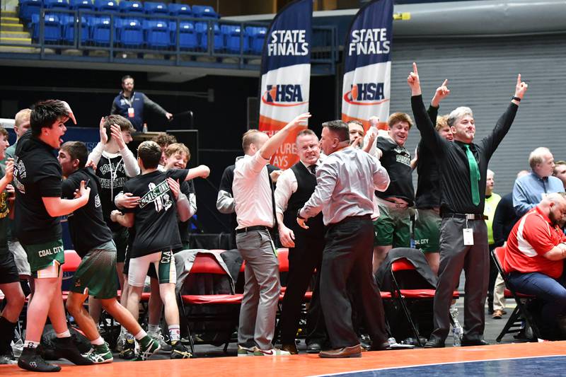 The Coal City bench erupts as Aidan Kenney secured his 144-pound match victory over Cole Yarbrough of Vandalia to earn the Coalers first place during the IHSA Dual Team State Finals in Bloomington on Saturday, March 1.