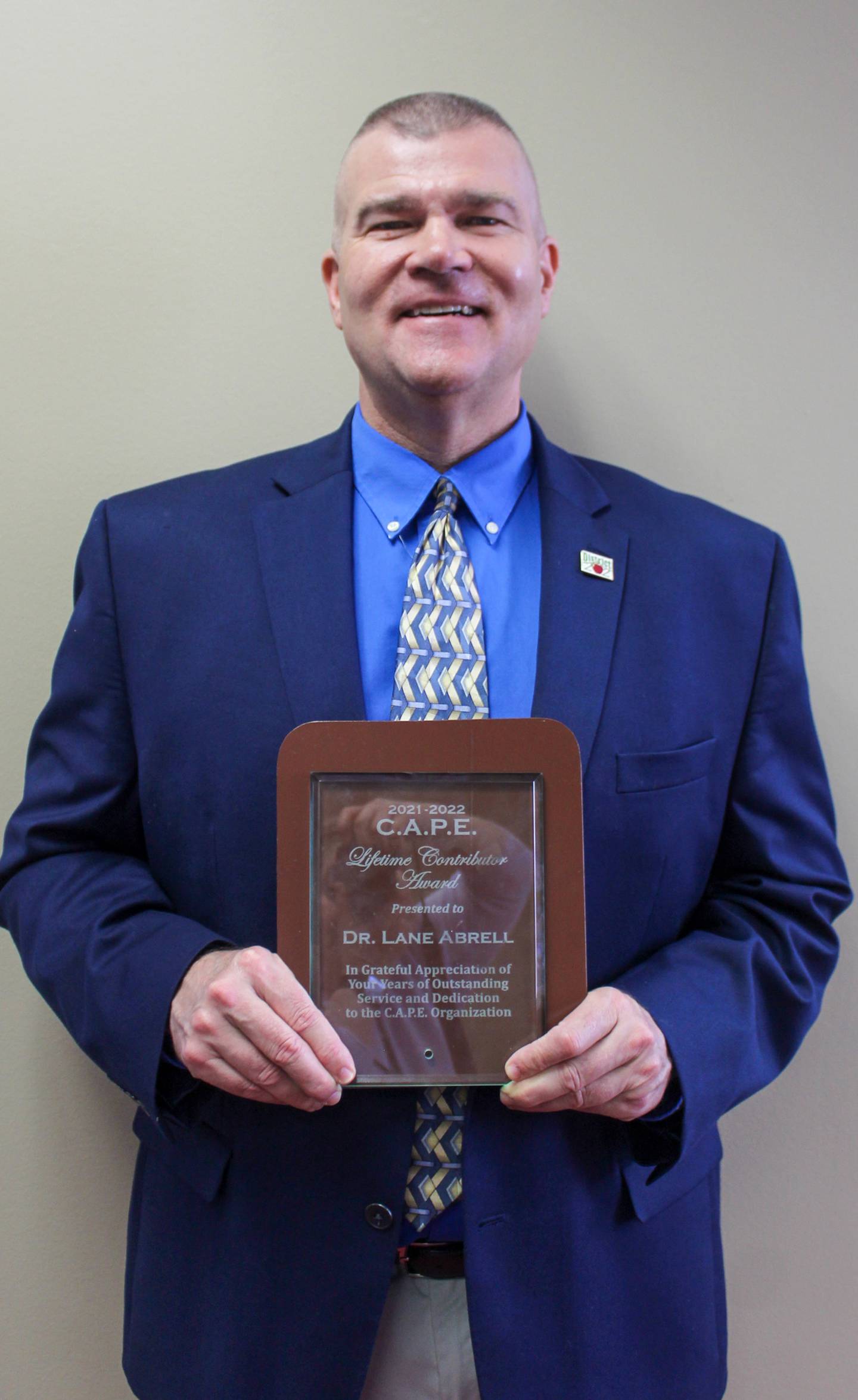 District 202 Superintendent of Schools Lane Abrell shows off his 2021-22 CAPE Lifetime Contributor" Award.