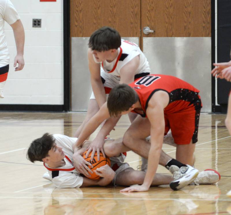 Amboy's Ezra Parker (21) and Bryson Deery (23) battle Fulton's Landen Leu (10) for a loose ball during a Friday, Jan. 17, 2025 game at Amboy High School.