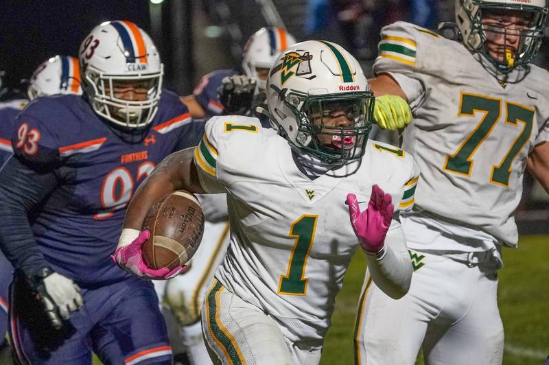 Waubonsie Valley's Chrisjan (1) carries the ball against Oswego during a Class 8A first-round playoff game at Oswego High School on Friday, Nov. 1, 2024.