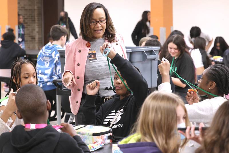 Treveda Redmond, principal at Huntley Middle School, makes sure that sixth-grade students are all wearing their ID’s Tuesday, March 14, 2023, at the school in DeKalb.