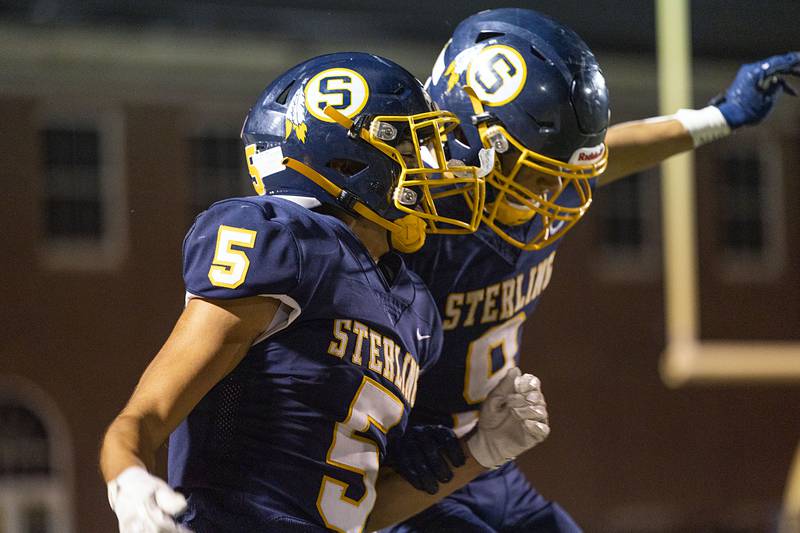 Sterling’s Mateo Vasquez (left) and AJ Kested celebrate the end of the first half Friday, Oct. 21, 2022 against United Township.