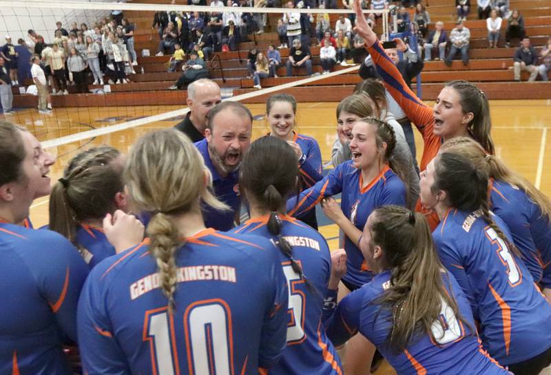 Members of the Genoa-Kingston volleyball team and their coach Keith Foster celebrate after defeating Quincy Notre Dame in three sets in the Class 2A Supersectional volleyball game on Friday, Nov. 4, 2022 at Princeton High School.