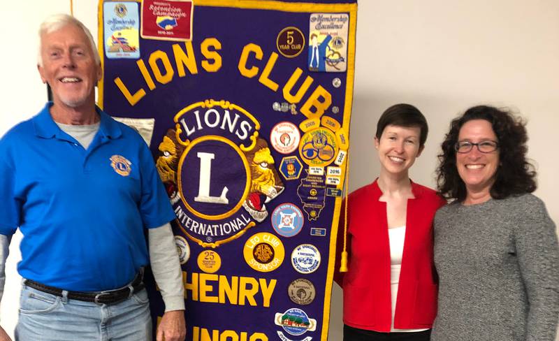 McHenry Lions Club president, the Rev. Gary Peterson, left, presents a donation April 25, 2022, for McHenry High School's Food for Thought program to English teacher Ashley Diedrich, center, and District Library Media Specialist Cheryl Myers, right, at the Wonder Lake public works facility in Wonder Lake.