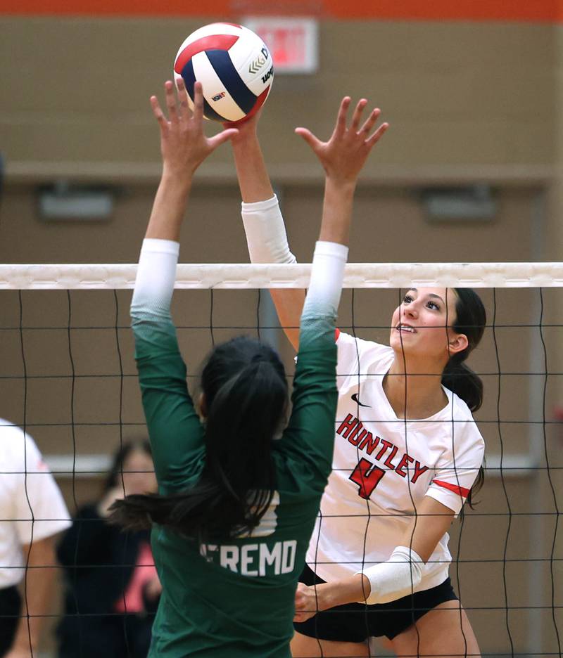 Huntley's Diellza Sejdini tries to spike the ball by Fremd's Akshara Jay Monday, Nov. 11, 2024, during their Class 4A supersectional match at DeKalb High School.
