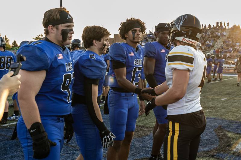 Lincoln-Way East and Metea Valley players shake hands prior to a varsity football game at Lincoln-Way East on Oct. 3, 2025.