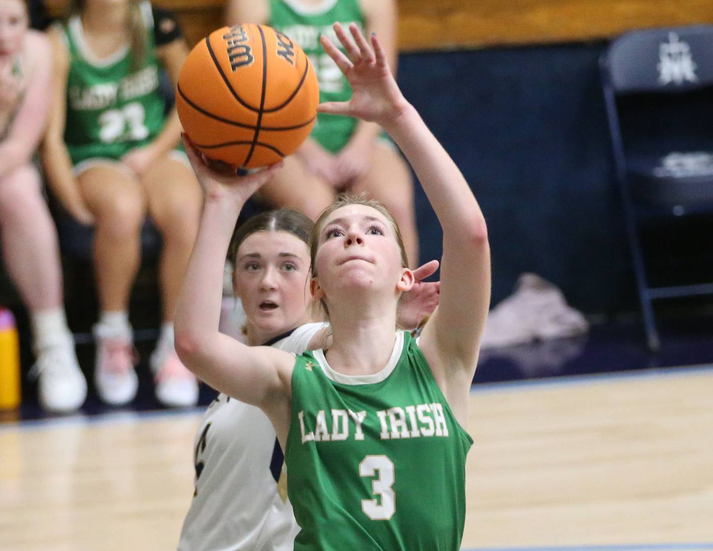 Seneca's Evelyn O'Connor eyes the hoop while dribbling in the lane past Marquette's Hunter Hopkins on Thursday, Dec. 5, 2024 in Bader Gym at Marquette High School.