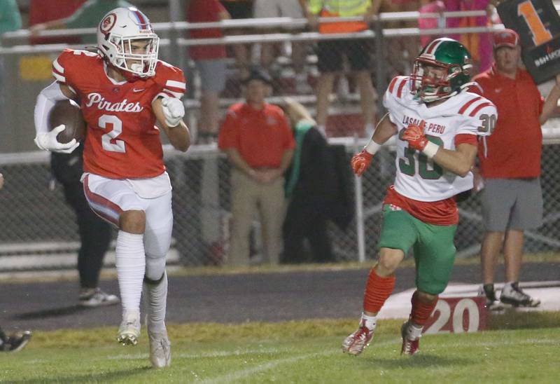 Ottawa's Andrew Vercolio runs the ball as L-P's Luca Verucchi chases after him on Friday, Sept. 12, 2025 at King Field.
