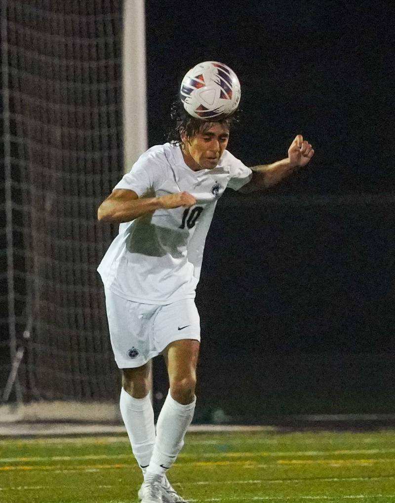 West Chicago's Alan Alfaro (10) heads the ball against St. Charles East during a class 3A sectional semifinal soccer match at West Chicago High School on Wednesday, Oct. 25, 2023.