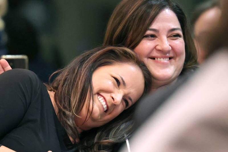 Cindy Green-Deutsch (left) leans on her friend Meropi Matarangas as she realizes that she is the 2022 recipient of the Athena Award Tuesday, Oct. 18, 2022, during the Athena and Women of Accomplishment Award reception at the Barsema Alumni and Visitors Center at Northern Illinois University in DeKalb.