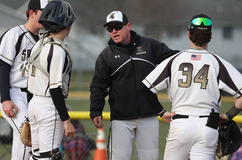 Sycamore head coach Jason Cavanaugh meets with his infielders on the mound during their game against St. Charles North Thursday, April 10, 2025, at the Sycamore Sports Complex.